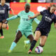 Two players battle for the ball