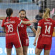 Lo'eau LaBonta celebrates with teammates Izzy Rodriguez and Claire Hutton in a match against the San Diego Wave in April 2025.