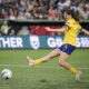 Paige Monaghan follows through on a right-footed kick.